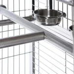 Stainless bird cage interior with metal perches and feeding bowls