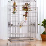 Spacious stainless bird cage with colorful toys and a parrot inside