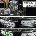 Stainless bird cage with intricate floral designs and decorative elements
