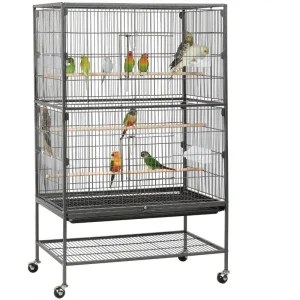 Stainless bird cage with colorful parrots perched on wooden perches